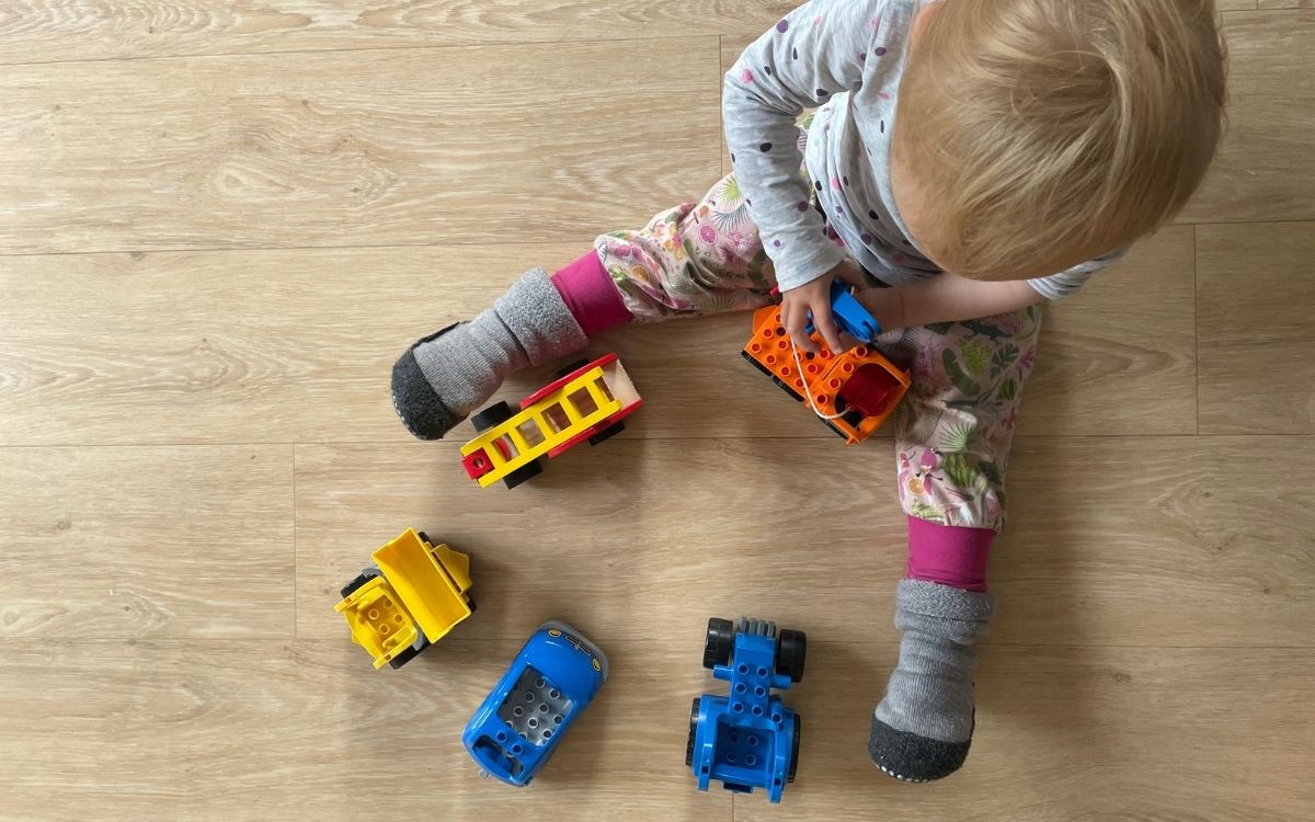 kid playing with cars